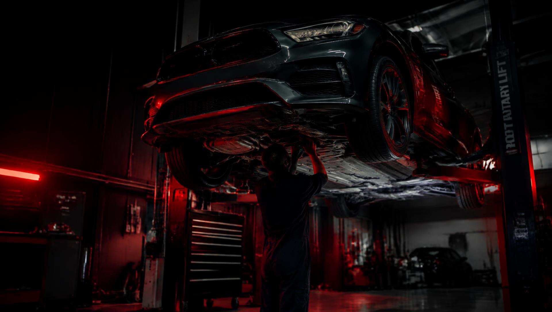 Mechanic working under a lifted car
